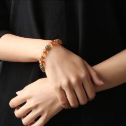 Alternative view of ខ្សែដៃត្បូង Rutilated Quartz ពណ៌ទាំង៣